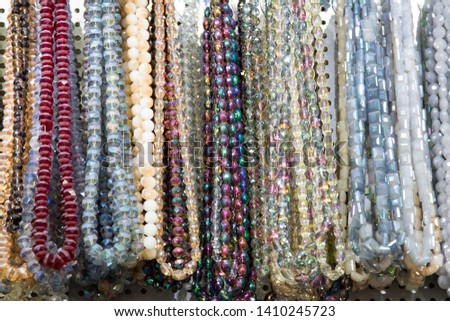 Multicolored handmade beads. Colorful background of the bead. Fashionable craft of women. Decoration of stones.