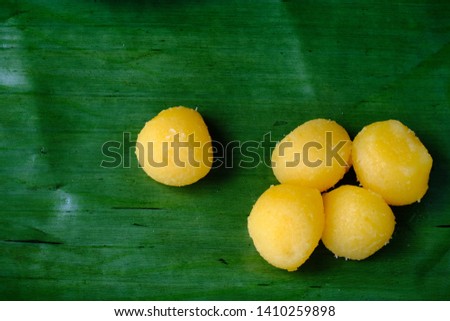 A picture of traditional Thai dessert, golden egg yolks drops, on banana leaf.