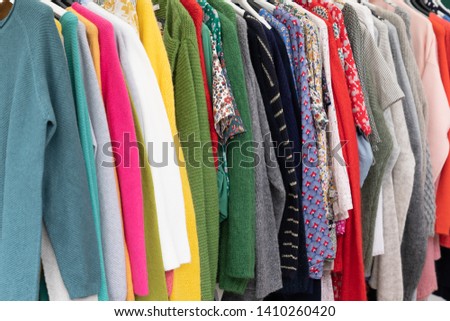 woman clothing on a rack in shop for background closeup photo