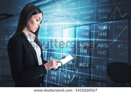 Attractive young european businesswoman using tablet with creative forex chart screen hologram with index in blurry office interior. HUD and trade concept. Double exposure 