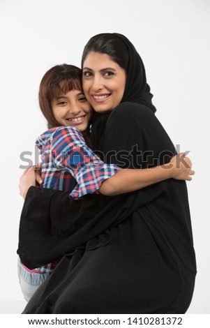 Portrait of an Arab mother and her daughter. Royalty-Free Stock Photo #1410281372
