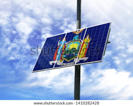 Solar panels against a blue sky with a picture of the flag State of New York
