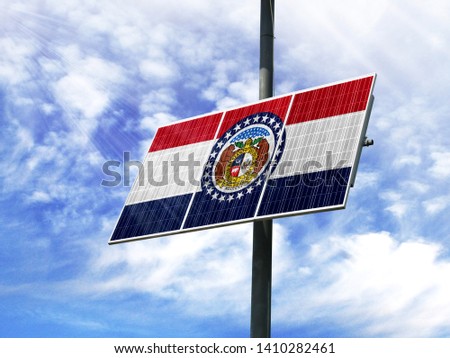 Solar panels against a blue sky with a picture of the flag State of Missouri