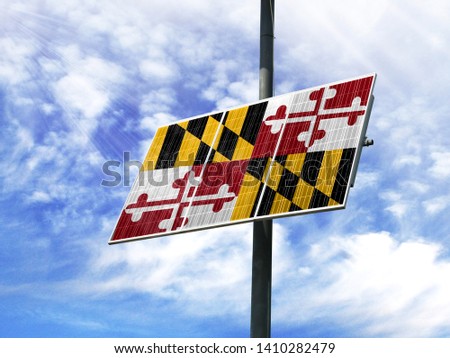 Solar panels against a blue sky with a picture of the flag State of Maryland