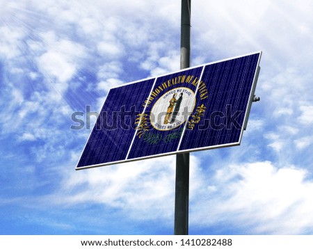 Solar panels against a blue sky with a picture of the flag State of Kentucky