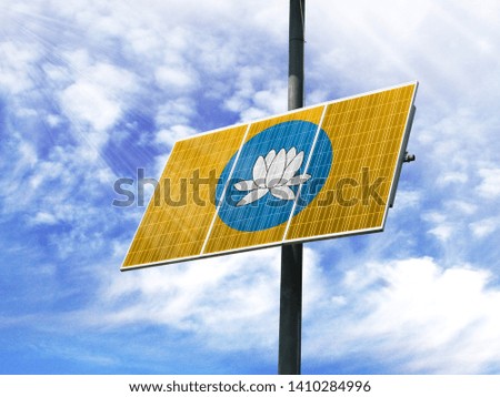 Solar panels against a blue sky with a picture of the flag of Kalmykia