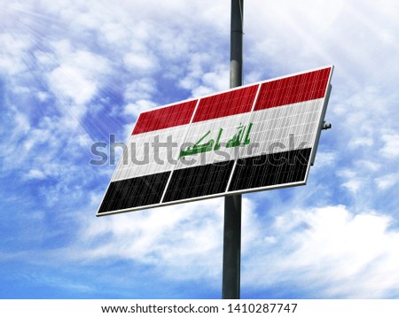 Solar panels against a blue sky with a picture of the flag of Iraq