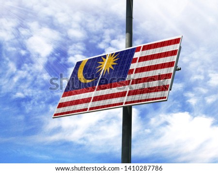 Solar panels against a blue sky with a picture of the flag of Malasia
