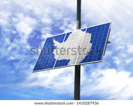 Solar panels against a blue sky with a picture of the flag of Antarctic