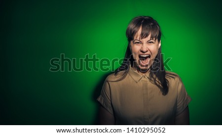 girl on a green background, shows different emotions