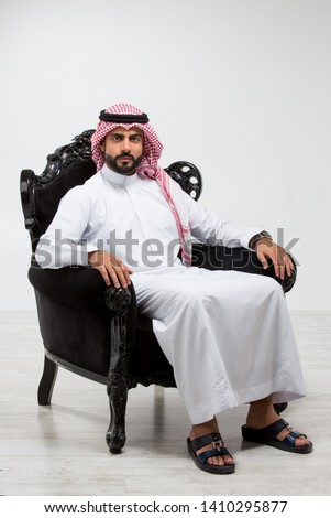 Portrait of an arab man sitting down. Royalty-Free Stock Photo #1410295877