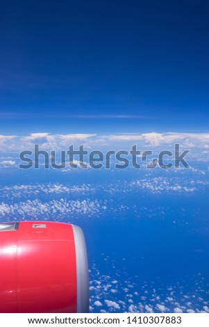 Nature background of sky and clouds. View from the window in the plane.