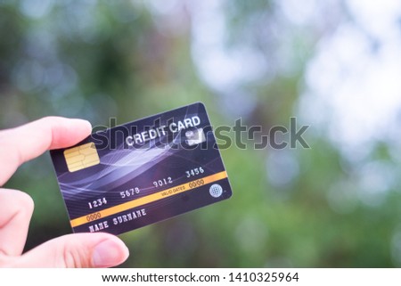 Men  hold credit card with bokeh background , Financial freedom concept