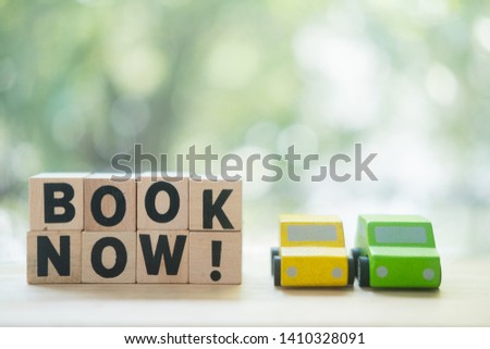 Miniatures car and wooden block words with book now. Concept of online car booking