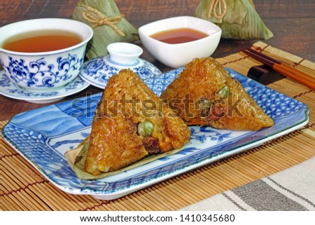 Sticky rice dumpling or Zongzi (Pyramid-shaped dumpling made by wrapping glutinious rice in bamboo leaves) Tradition food for Chinese Boat dragon festival (5th Lunar month festvial, Duanwu Festival).