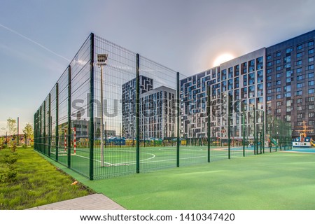 Sports ground in courtyard of residential complex. Public sports grounds for team games of sport, basketball, football, volleyball, handball in residential area, of educational institutions city Royalty-Free Stock Photo #1410347420