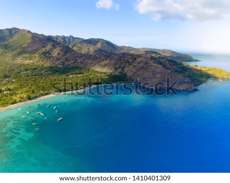 Tropical paradise beach with white sand and coco palms travel tourism wide panorama background concept. Drone Lombok Island
