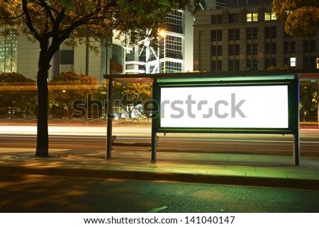Road car light trails through at modern city advertising light boxes