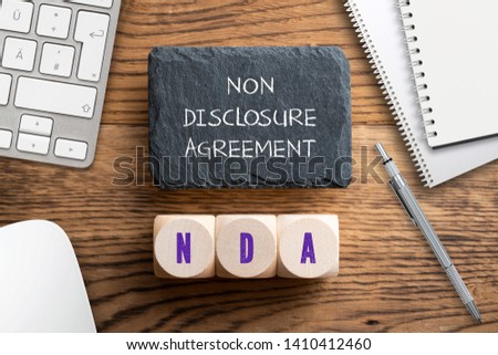 Cubes with acronym NDA for "non disclosure agreement" on wooden background