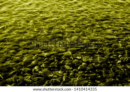 Golden stones and water. Texture and background
