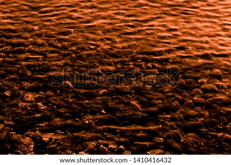 Coffee-colored stones and water. Texture and background
