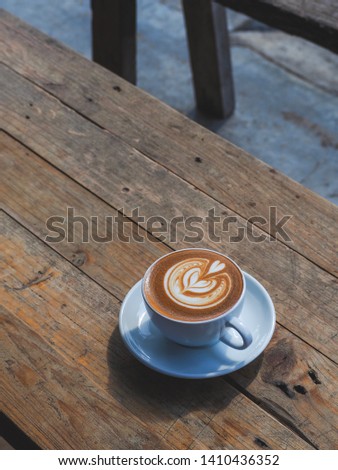A cup of coffee on wooden table in the moring