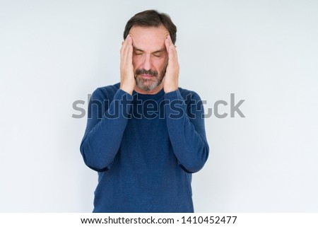 Elegant senior man over isolated background with hand on head for pain in head because stress. Suffering migraine. Royalty-Free Stock Photo #1410452477