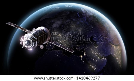 Space craft and Earth at night in outer space. City lights. Elements of this image furnished by NASA
