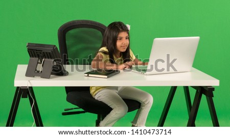 Young arab girl using laptop Royalty-Free Stock Photo #1410473714