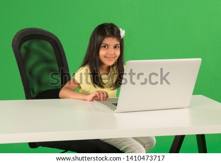 Young arab girl using laptop Royalty-Free Stock Photo #1410473717