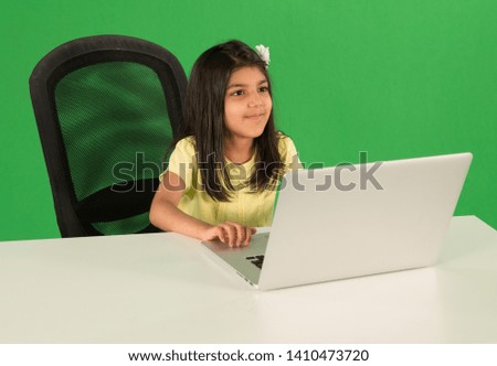 Young arab girl using laptop Royalty-Free Stock Photo #1410473720