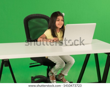 Young arab girl using laptop Royalty-Free Stock Photo #1410473723