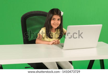 Young arab girl using laptop Royalty-Free Stock Photo #1410473729