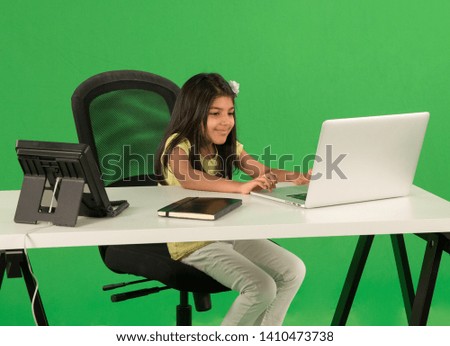 Young arab girl using laptop Royalty-Free Stock Photo #1410473738