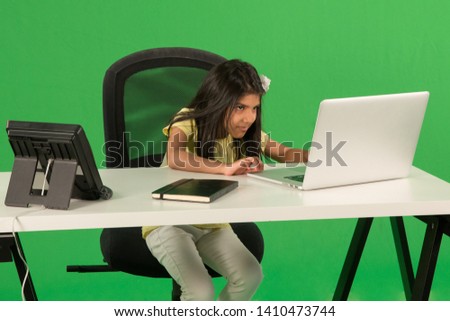 Young arab girl using laptop Royalty-Free Stock Photo #1410473744