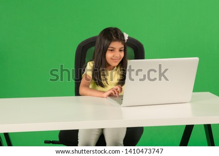 Young arab girl using laptop Royalty-Free Stock Photo #1410473747