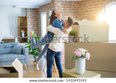 Beautiful couple jumping and hugging in love, smiling very happy