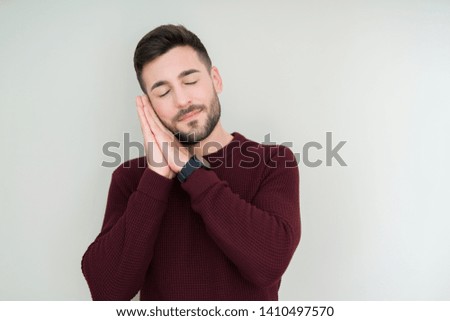 Young handsome man wearing a sweater over isolated background sleeping tired dreaming and posing with hands together while smiling with closed eyes.