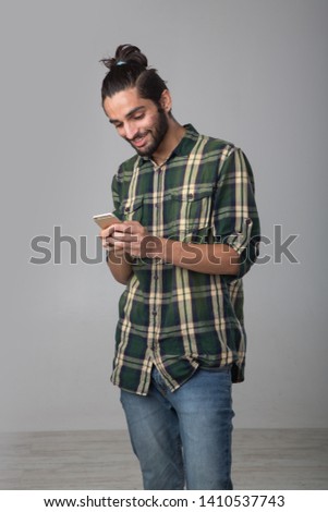 Portrait of an Expat Arab using a mobile phone. Royalty-Free Stock Photo #1410537743