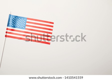 top view of american flag on stick white background with copy space