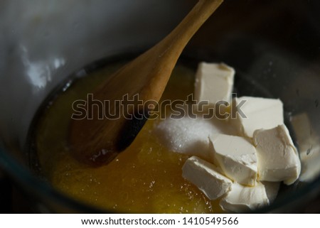 Making batter in the pot on simmerng water for russian honey cake Royalty-Free Stock Photo #1410549566
