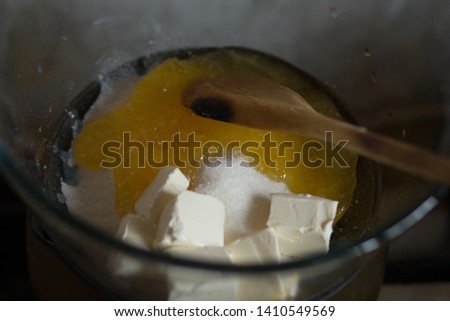 Making batter in the pot on simmerng water for russian honey cake Royalty-Free Stock Photo #1410549569
