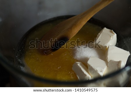 Making batter in the pot on simmerng water for russian honey cake Royalty-Free Stock Photo #1410549575