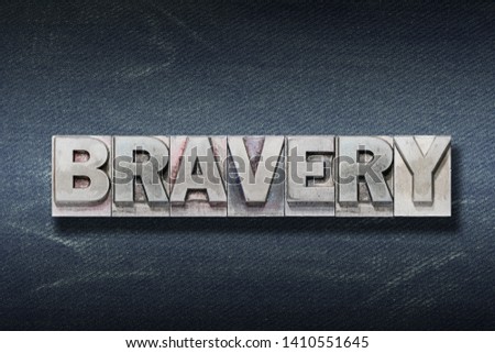 bravery word made from metallic letterpress on dark jeans background Royalty-Free Stock Photo #1410551645