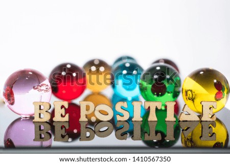 Abstract composition with transparent glass balls and wooden letters.