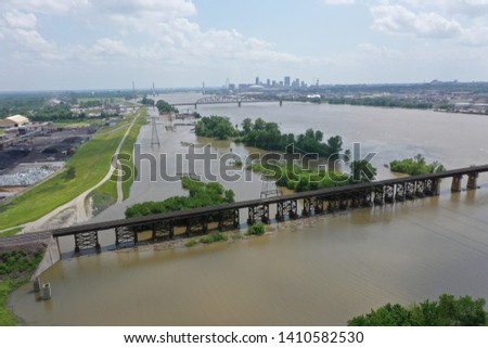 Aerial photo of the Mississippi River at St Louis where flood waters are near the top of the levee Royalty-Free Stock Photo #1410582530