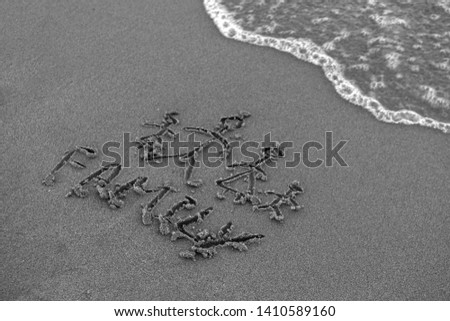 Word  Family handwritten and family with parents and children drawn in the sand near the sea.
 Royalty-Free Stock Photo #1410589160