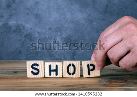 Shop - word from wooden letters on wooden table