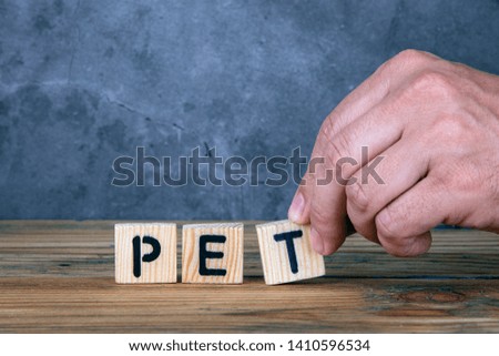 Pet - word from wooden letters on wooden table