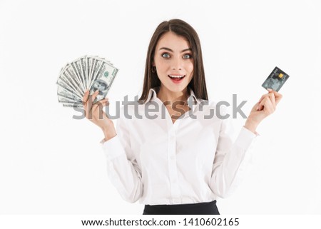 Photo of attractive female worker businesswoman dressed in formal wear holding cash money and credit card while working in office isolated over white background